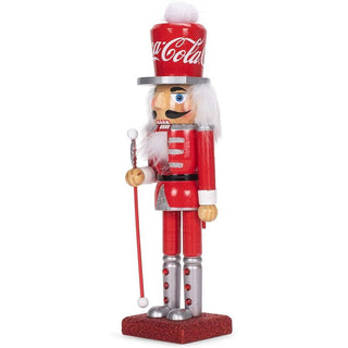 Kurt Adler 10-inch Coca-Cola branded wooden nutcracker figure in red uniform holding a staff