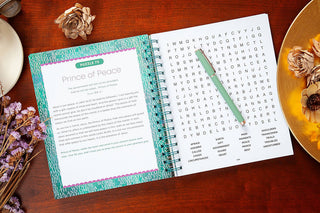 Angled open Bible word search book displaying Prince of Peace puzzle with Isaiah verse reference and mint green pen