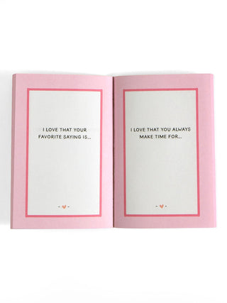 Open pink prompted journal showing interior pages with mom-themed fill-in prompts and heart accents