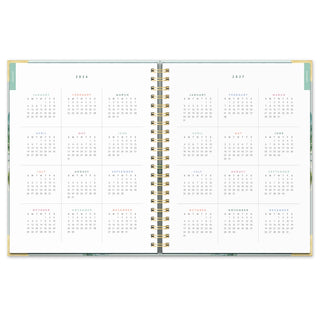 Open spiral planner showing full-year 2026 and 2027 monthly calendar pages