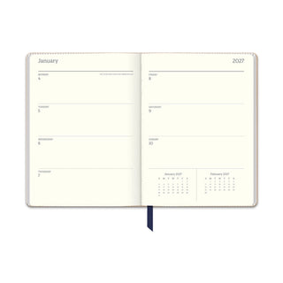 Daily Monday Thursday blocks in January 2027 navy planner spread with monthly calendar inset on cream paper