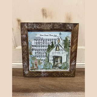 Distressed wooden frame holding white church canvas layered over How Great Thou Art sheet music