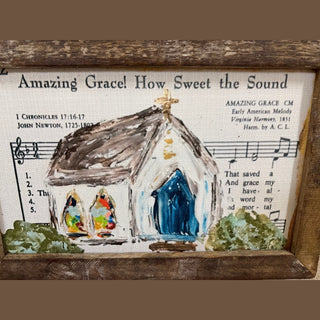Rustic framed art featuring white church with blue door on vintage Amazing Grace sheet music