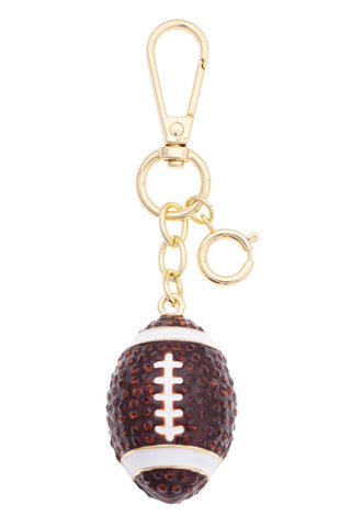 3D football-shaped bag charm in brown and white enamel with gold-tone hardware and clip