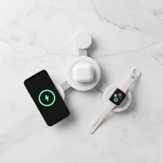 Sanis 3-in-1 white wireless charger simultaneously charging iPhone, AirPods, and Apple Watch on marble surface
