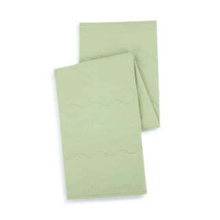 Pair of sage green weighted cooling lap blankets with decorative wave stitching, folded neatly