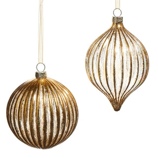 Two gold ribbed glass Christmas ornaments, one round and one teardrop-shaped, hanging on cream ribbons.