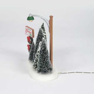Department 56 lit Christmas tree lot display with miniature snow-covered trees and street lamp