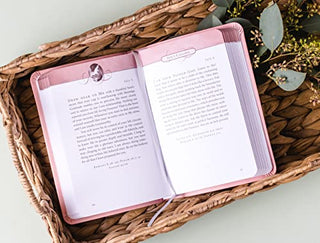 Jesus Calling devotional book open to daily reading, pink leathersoft cover with gilt-edged pages