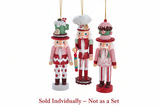 Set of three glittery holiday nutcracker ornaments themed as cake, cocoa, and gingerbread baker