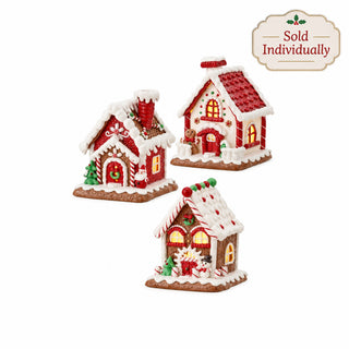 Set of three LED lighted clay gingerbread houses with red roofs and white snow accents