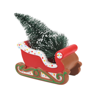 Red gingerbread-decorated Christmas sleigh with small evergreen tree and colorful polka dot trim
