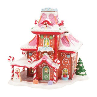 Department 56 Christmas village gingerbread-style house with snow and candy cane decorations