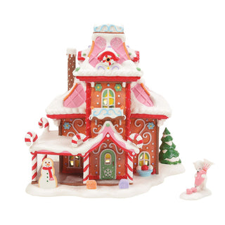 Department 56 gingerbread-style Christmas village house with candy cane decorations and snow details