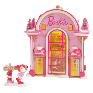 Pink Barbie-themed Christmas village building with Santa figure and decorative snow trees