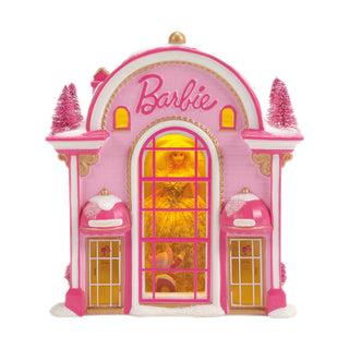 Pink Barbie-themed decorative house with Christmas trees and illuminated windows