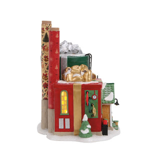 Department 56 Christmas village wrapping paper factory building with illuminated windows and snow details