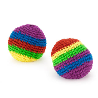Two crocheted rainbow striped kickballs with colorful yarn bands on white background