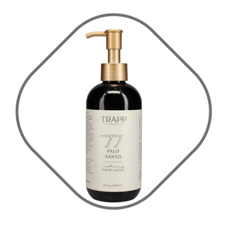 Trapp No. 77 Palo Santo Hand Lotion in matte black glass bottle with gold pump and cream label