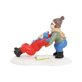 Department 56 figurine showing child helping fallen person on snowy base