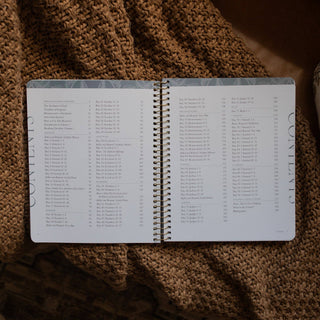 Spiral-bound Bible study book open to table of contents showing Genesis through 2 Samuel