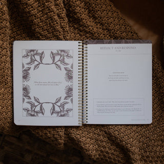 Open spiral-bound Bible study journal showing floral art page and Leviticus 20:26 reflection prompts