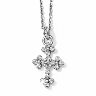 Close-up of silver Abbey Cross pendant showing four-petal crystal floral settings and metallic bead details