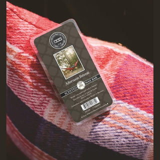 Afternoon Retreat scented wax bar on red plaid fabric showing rustic home fragrance setting