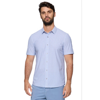 Man wearing a light blue patterned shirt and pants 