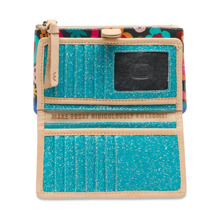 Small wallet with turquoise front panel and floral patterned back, featuring a motivational quote.