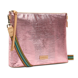 Pink textured clutch bag with a colorful strap