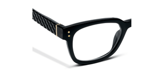 Close-up detail of Peepers Aubrey black eyeglasses showing textured temple arm and gold hardware