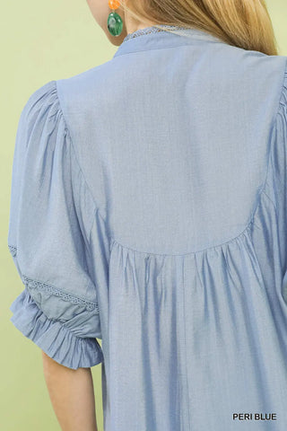 Light blue dress with ruffled sleeves on a person