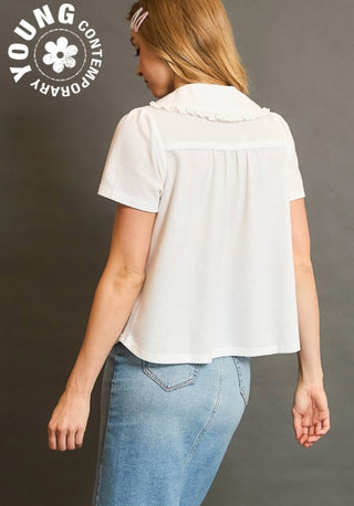 Woman wearing a white blouse and blue jeans with 'Young Contemporary' logo.