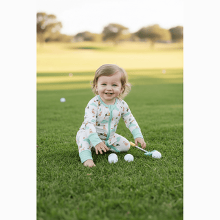 Barks & Birdies Zippie on grassy lawn with golf balls