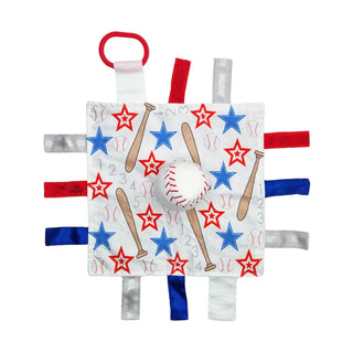 Top down view of white square lovey with red blue stars and six textured ribbons