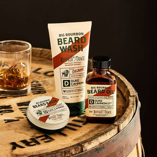 Duke Cannon Big Bourbon Beard Wash 6oz displayed on whiskey barrel with matching beard care products