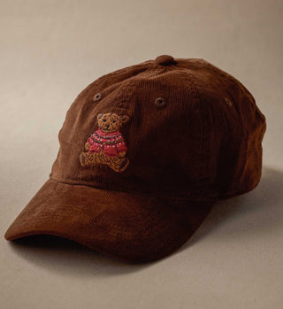 Brown corduroy baseball cap with embroidered teddy bear wearing a red Christmas sweater