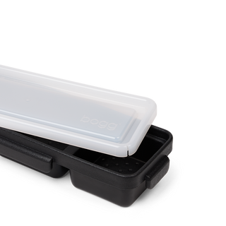 Bogg Baby Bento box in black with translucent white lid partially open on white background