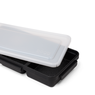 Bogg Bento box accessory in black with frosted white lid, shown partially open on white background.
