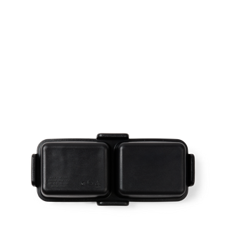 Bottom view of Bitty Bento Bogg bag in matte black showing dual compartment lids and latch