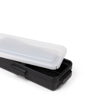 Bogg Bitty Bento box in black with translucent white lid, shown partially open on white background.