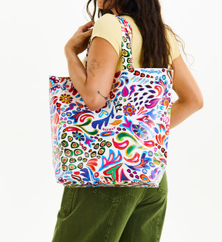 Model carrying Consuela Grab N Go Basic tote bag in vibrant multicolor Bianca print over shoulder