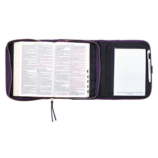 Open purple tri-fold Bible cover organizer with notepad, pen holder, and Bible inside