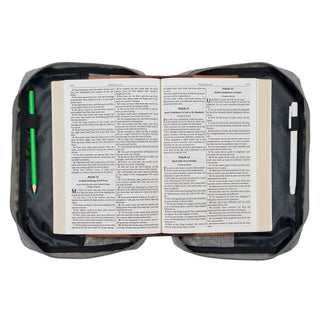 Gray Bible cover open displaying Psalms pages with pencil and pen inside