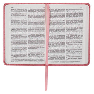 Open pink faux leather NLT New Testament Bible showing John chapters 3 and 4 with pink ribbon bookmark