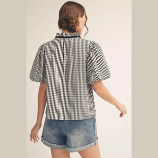 Black and white gingham top back view with pleated ruffle neckline and short puff sleeves