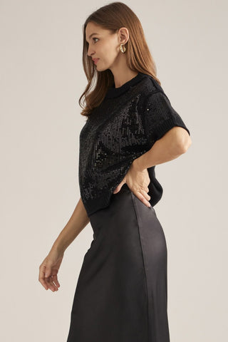 Entro black sequin short-sleeve sweater with mock neck, styled with satin midi skirt