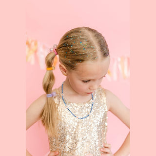Girl wearing blue teal glitter along hairline and crown in center part style