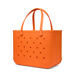 Bogg Bag Baby tote in orange with small pumpkin cutout details and top handles